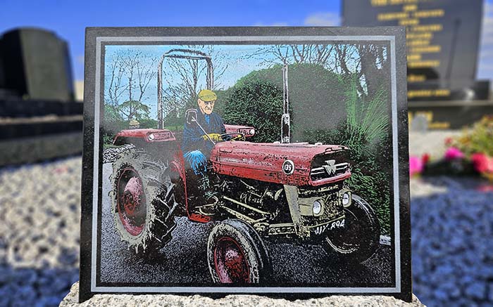 Grave plaque with man on tractor hand painted in colour